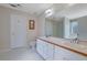 A bright bathroom featuring double sinks, white cabinets and a large mirror at 954 Josie Ct, Lawrenceville, GA 30045