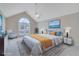 Staged main bedroom features vaulted ceiling, large window and coastal decor at 954 Josie Ct, Lawrenceville, GA 30045