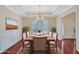 Dining room has a tray ceiling, modern chandelier, and wainscoting at 954 Josie Ct, Lawrenceville, GA 30045