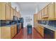 The kitchen has stainless appliances, hardwood floors, and light wood cabinets at 954 Josie Ct, Lawrenceville, GA 30045