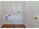 A utility room with hardwood floors, and ample space for a washer and dryer at 954 Josie Ct, Lawrenceville, GA 30045