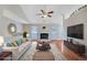 Bright living room with fireplace, hardwood floors, and neutral decor at 954 Josie Ct, Lawrenceville, GA 30045