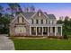 Charming two-story brick home with a welcoming front porch and meticulously manicured lawn at 1073 Sweet Mia Ln, Powder Springs, GA 30127