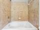 Close-up of a bathtub with tile walls and shower head at 2252 Limehurst Ne Dr, Atlanta, GA 30319