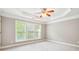 Spacious bedroom with trey ceiling, carpet, and large windows at 2252 Limehurst Ne Dr, Atlanta, GA 30319