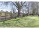 A dog park with an expansive artificial lawn and perimeter fence, shaded by a mature tree at 2252 Limehurst Ne Dr, Atlanta, GA 30319