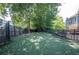 Fenced dog park area features mature trees, artificial grass, and benches; great for pets and outdoor fun at 2252 Limehurst Ne Dr, Atlanta, GA 30319