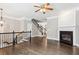 Open-concept living room with dark hardwood floors, staircase, and fireplace feature at 2252 Limehurst Ne Dr, Atlanta, GA 30319