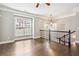 Open living space with hardwood floors, large window, and elegant railing at 2252 Limehurst Ne Dr, Atlanta, GA 30319