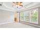 Roomy bedroom with tray ceiling, large windows, and neutral carpet at 2252 Limehurst Ne Dr, Atlanta, GA 30319