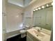 Bathroom with a bathtub and shower, a sink and vanity, and black tiled floors at 2259 Pernoshal Ct, Dunwoody, GA 30338
