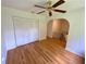 Bedroom featuring hardwood floors, a ceiling fan, an archway and a closet with folding doors at 2259 Pernoshal Ct, Dunwoody, GA 30338