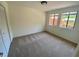 Bright bedroom features neutral carpet, two windows, and a closet for storage solutions at 2259 Pernoshal Ct, Dunwoody, GA 30338