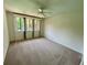 Bright carpeted bedroom with a ceiling fan and a set of windows at 2259 Pernoshal Ct, Dunwoody, GA 30338
