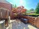 Backyard patio featuring brick walls, a storage bench, an AC unit, and an enclosed sunroom at 2259 Pernoshal Ct, Dunwoody, GA 30338