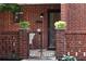 Close-up of brick home's entrance with decorative iron gate, plants, and address number at 2259 Pernoshal Ct, Dunwoody, GA 30338