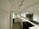 Modern kitchen featuring track lighting, white cabinets, and updated appliances at 2259 Pernoshal Ct, Dunwoody, GA 30338