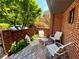 Brick-enclosed patio with outdoor furniture and a view of the surrounding greenery at 2259 Pernoshal Ct, Dunwoody, GA 30338