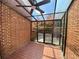 Enclosed patio with brick accents, tile flooring, and a ceiling fan at 2259 Pernoshal Ct, Dunwoody, GA 30338