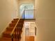 Stairway featuring hardwood steps, a black railing and a view into the kitchen on the floor below at 2259 Pernoshal Ct, Dunwoody, GA 30338