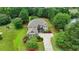 Beautiful two-story home features a well-manicured lawn, lush landscaping, and a paved driveway leading to the front entrance at 3120 Caney Creek Ln, Cumming, GA 30041