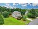 Aerial view of a home with an expansive yard, surrounded by lush greenery and mature trees for a peaceful retreat at 3120 Caney Creek Ln, Cumming, GA 30041