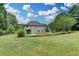 A sprawling backyard with lush grass and mature trees surrounds this two-story home, offering a private outdoor retreat at 3120 Caney Creek Ln, Cumming, GA 30041