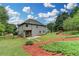 A spacious backyard with lush grass and mature trees surrounds this two-story home, offering a private outdoor retreat at 3120 Caney Creek Ln, Cumming, GA 30041