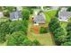 This aerial view shows the home nestled within trees and green landscaping at 3120 Caney Creek Ln, Cumming, GA 30041