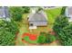 A view of the back of the home, with a lawn, landscaping, and a wooden fence at 3120 Caney Creek Ln, Cumming, GA 30041