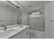 The bathroom features dual sinks, a shower and tub combo with glass doors at 3120 Caney Creek Ln, Cumming, GA 30041