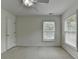 This bedroom features a ceiling fan, two windows, and light colored walls at 3120 Caney Creek Ln, Cumming, GA 30041