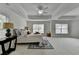Inviting primary bedroom features a tray ceiling, a ceiling fan, and plenty of space at 3120 Caney Creek Ln, Cumming, GA 30041