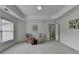 Spacious primary bedroom features tray ceilings, large windows, and sitting area at 3120 Caney Creek Ln, Cumming, GA 30041