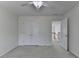 This bedroom features a ceiling fan, a double closet, and light colored walls at 3120 Caney Creek Ln, Cumming, GA 30041