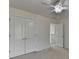 This bedroom features a ceiling fan, a double closet, and light colored walls at 3120 Caney Creek Ln, Cumming, GA 30041