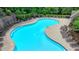 Community pool with surrounding lounge chairs, tables, and lush greenery, offering a relaxing atmosphere at 3120 Caney Creek Ln, Cumming, GA 30041