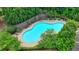 An aerial view of a community pool surrounded by lounge chairs, tables, and lush greenery at 3120 Caney Creek Ln, Cumming, GA 30041