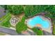 Aerial view of a community pool, playground, seating, and a grassy area at 3120 Caney Creek Ln, Cumming, GA 30041