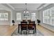 Elegant dining room with wood floors, decorative chandelier, and large windows for natural light at 3120 Caney Creek Ln, Cumming, GA 30041
