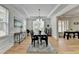 Formal dining room featuring elegant chandelier, wood floors, and multiple windows at 3120 Caney Creek Ln, Cumming, GA 30041