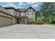 Traditional brick home with manicured landscaping and a spacious three car driveway at 3120 Caney Creek Ln, Cumming, GA 30041
