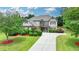Charming two-story home with manicured lawn, lush landscaping, and a spacious driveway at 3120 Caney Creek Ln, Cumming, GA 30041