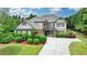 Charming two-story home with manicured lawn, lush landscaping, and a spacious driveway at 3120 Caney Creek Ln, Cumming, GA 30041