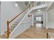 Spacious foyer with hardwood floors, a staircase, and open view to the living room at 3120 Caney Creek Ln, Cumming, GA 30041