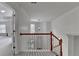 Bright foyer with wood railing, chandelier, and window providing natural light at 3120 Caney Creek Ln, Cumming, GA 30041