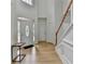Bright foyer featuring hardwood floors, stairs, and front door with sidelights at 3120 Caney Creek Ln, Cumming, GA 30041