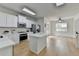 Bright, updated kitchen open to the dining area featuring an island and stainless steel appliances at 3120 Caney Creek Ln, Cumming, GA 30041