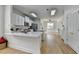 Modern kitchen flowing into living area, featuring white cabinetry and stainless appliances at 3120 Caney Creek Ln, Cumming, GA 30041