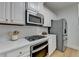 Kitchen featuring stainless steel oven, microwave, refrigerator, gas cooktop, and white cabinets at 3120 Caney Creek Ln, Cumming, GA 30041